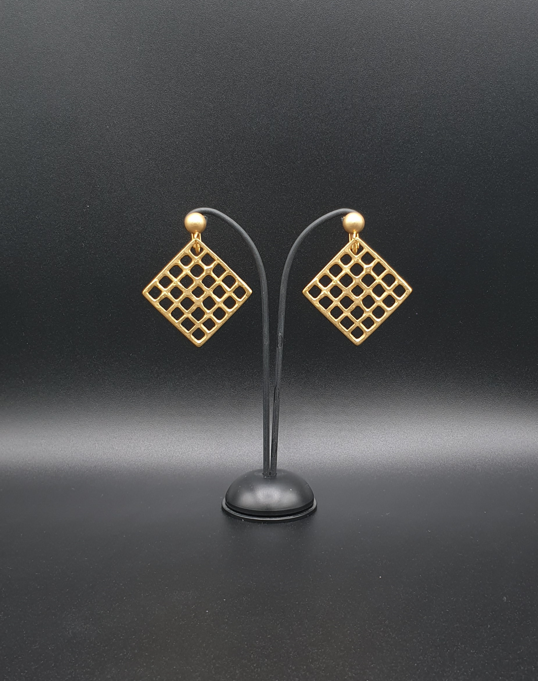 golden metal clip-on earrings with decorative square elements