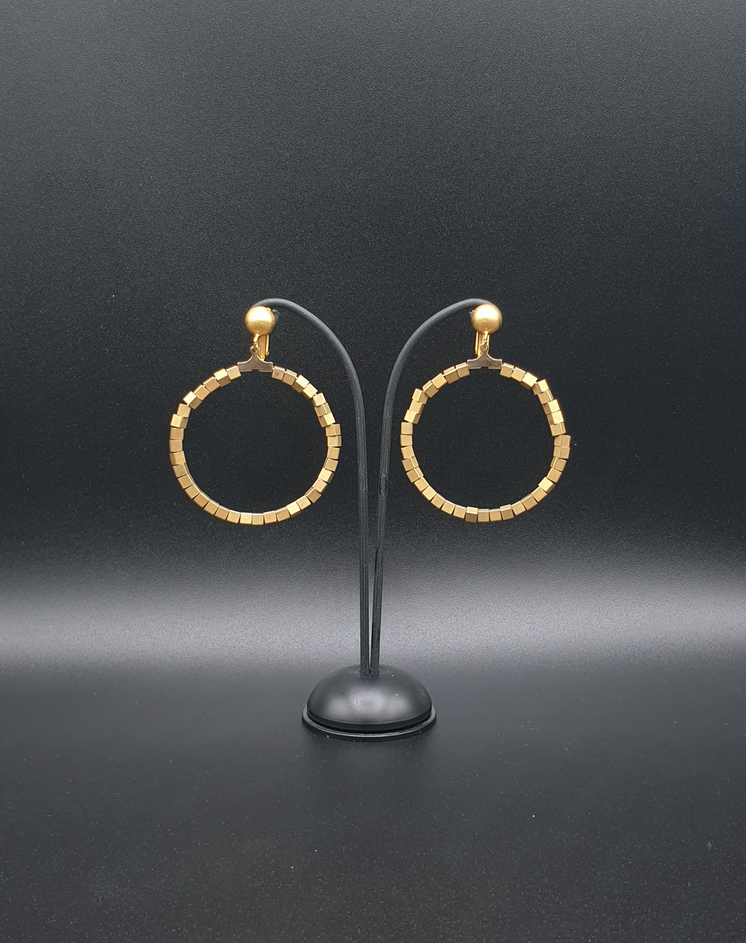 golden metal clip-on earrings with cubic beads