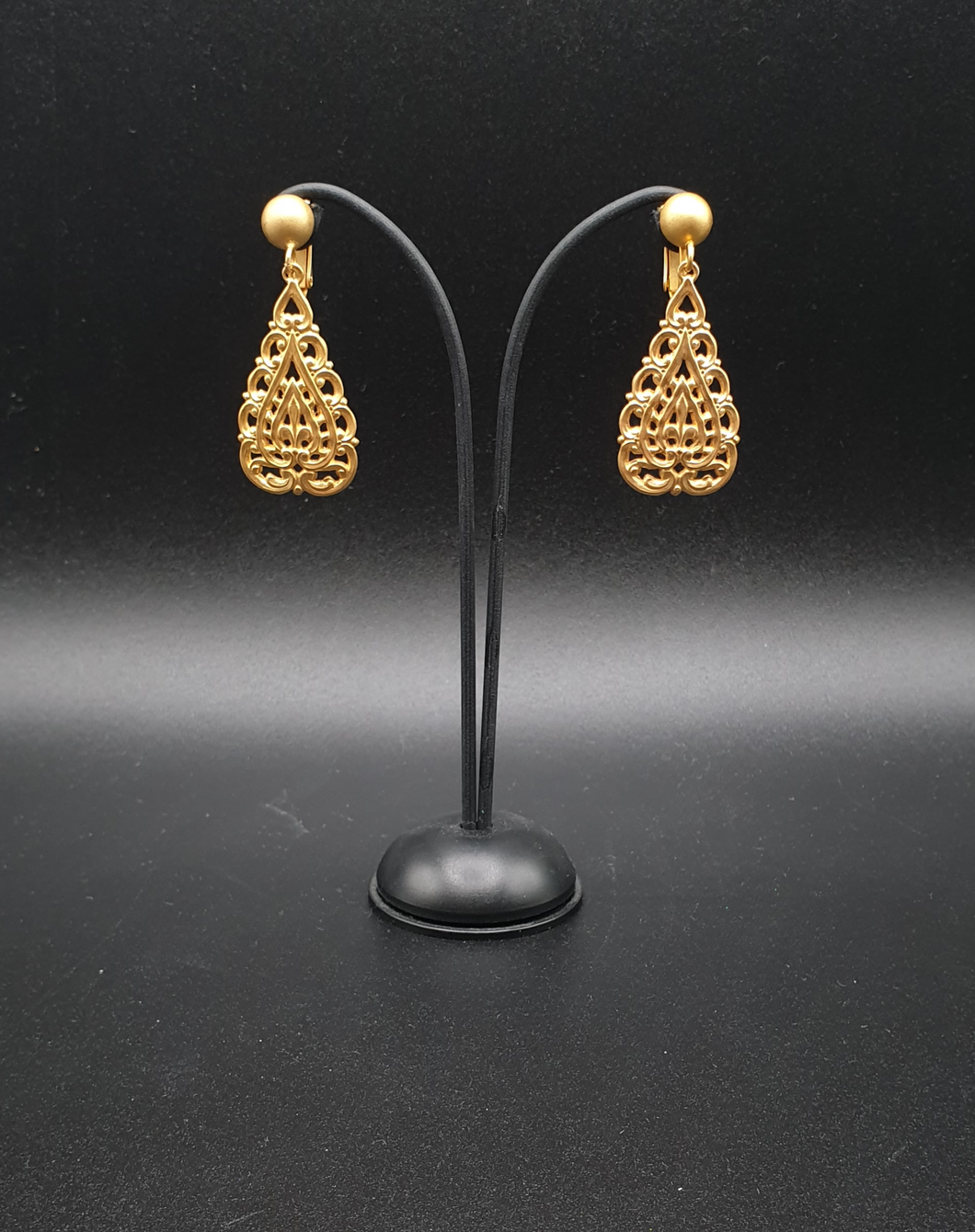 golden metal clip-on earrings with decorative elements