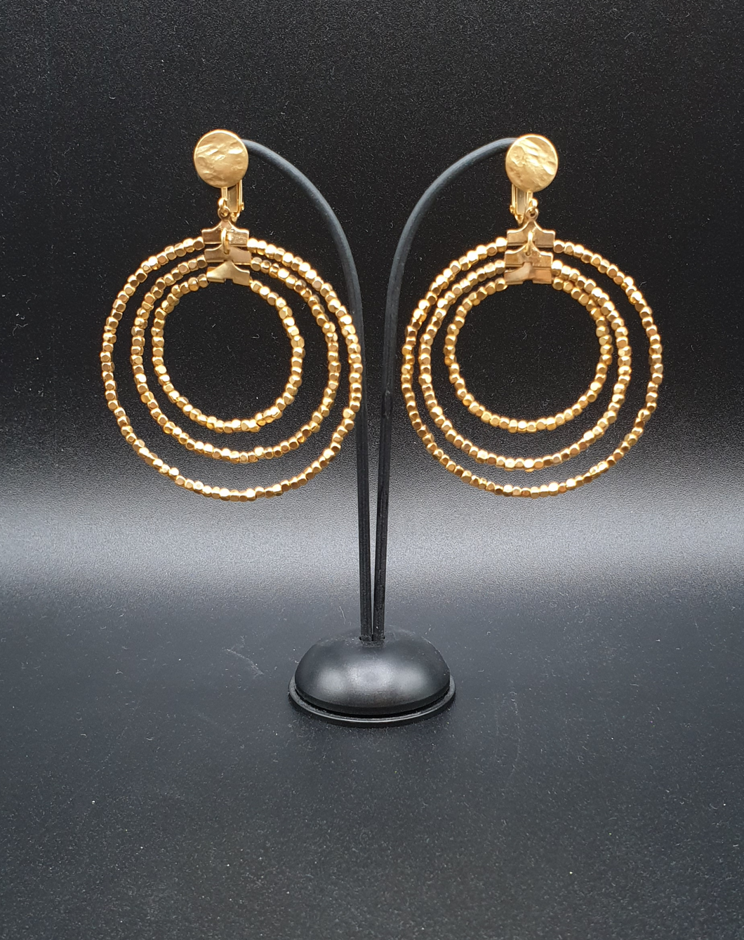 golden metal clip-on earrings with gold plated beads in three circles