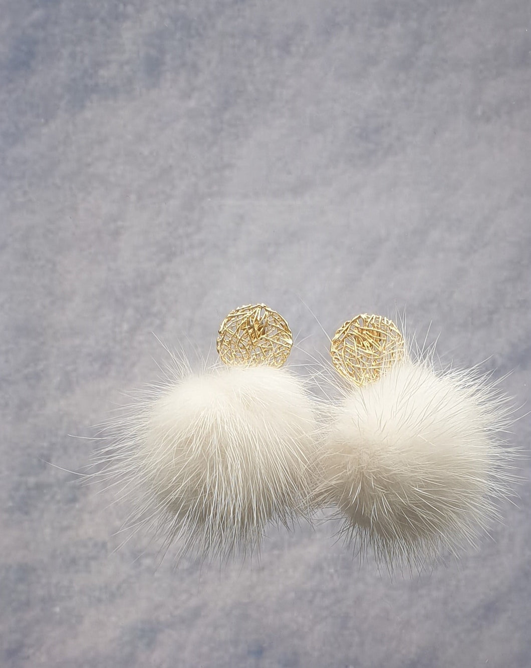 golden metal stud earrings with white coloured mink