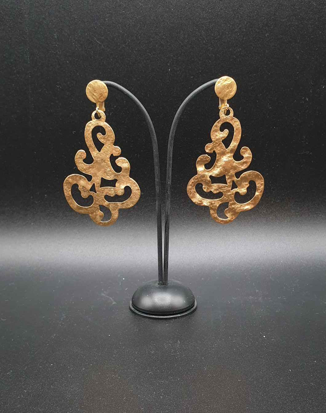 golden metal clip-on earrings with decorative elements