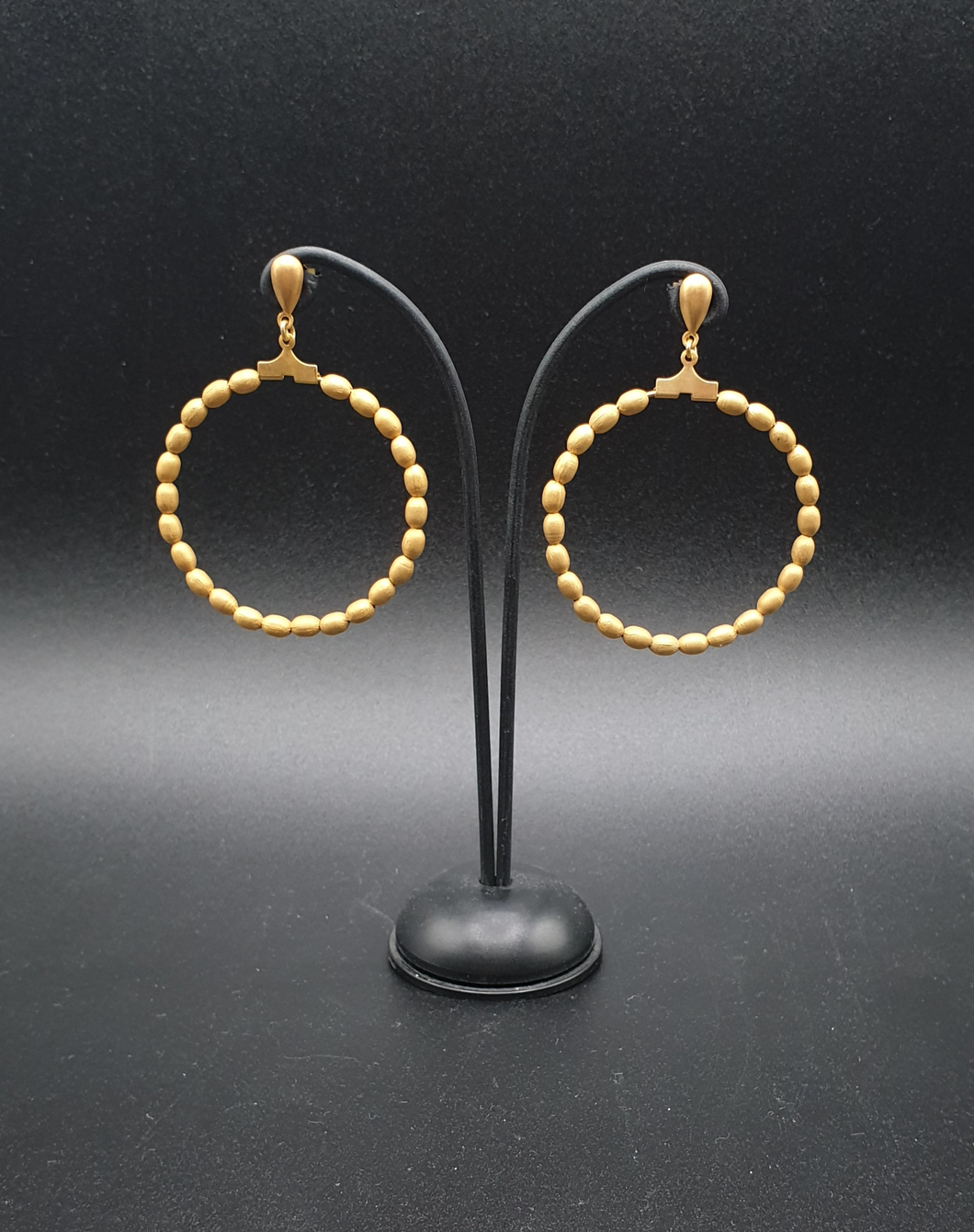 golden metal stud earrings with oval beads