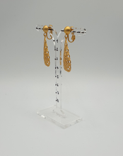 Load image into Gallery viewer, golden metal clip-on earrings with decorative elements
