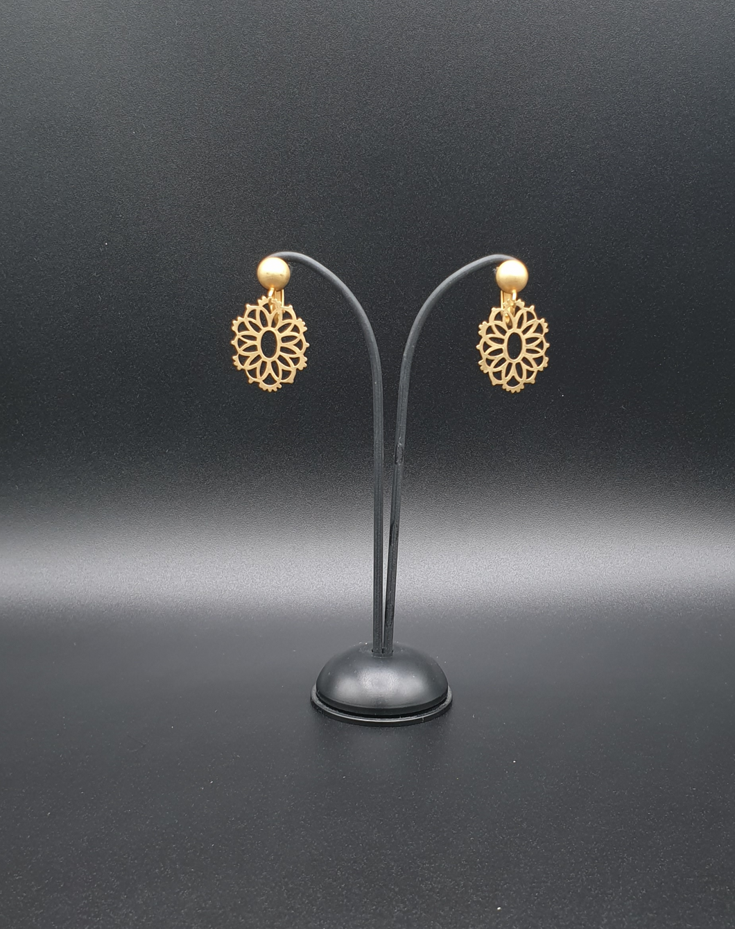 golden metal clip-on earrings with decorative element