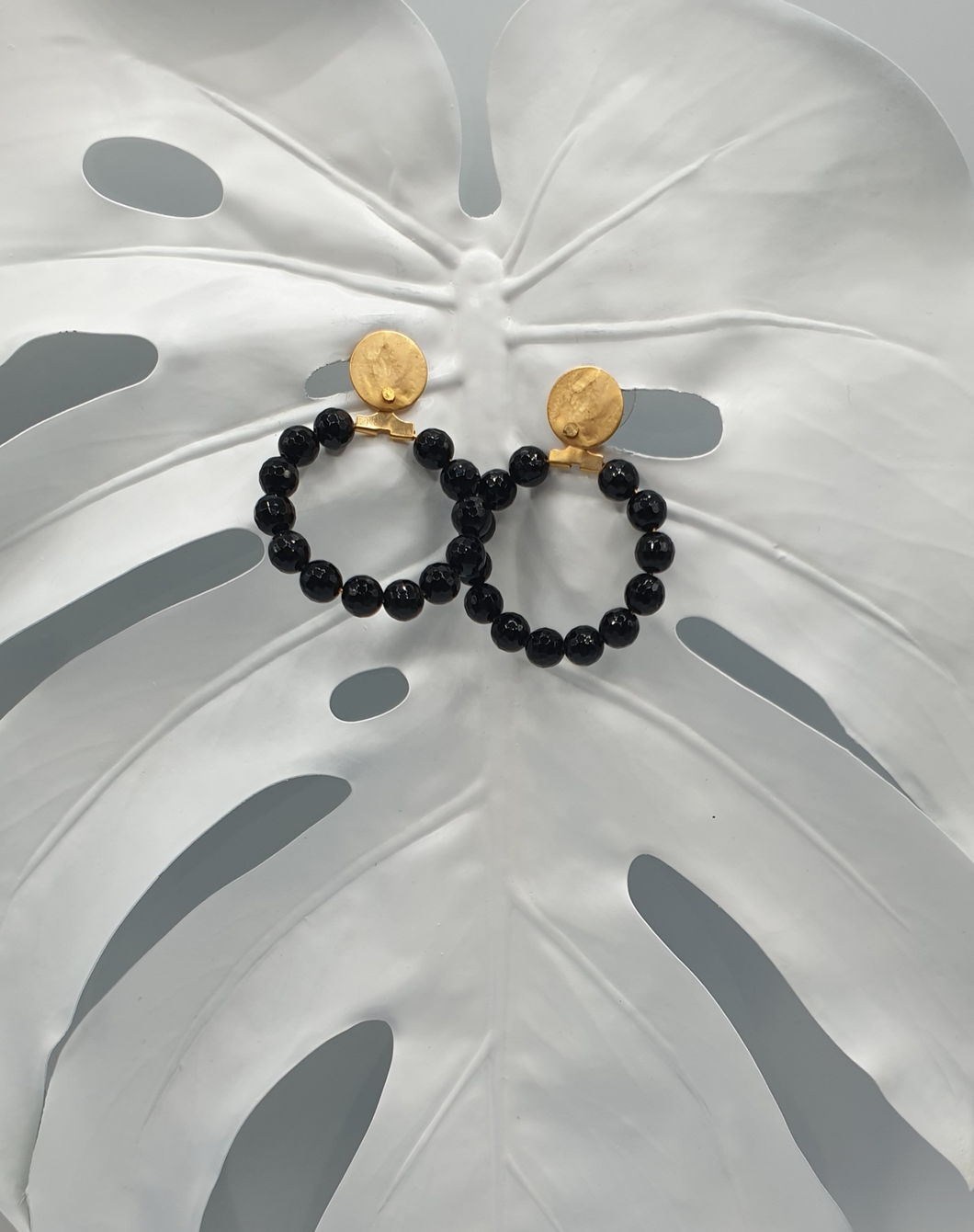 golden metal stud earrings with facetted black agate beads