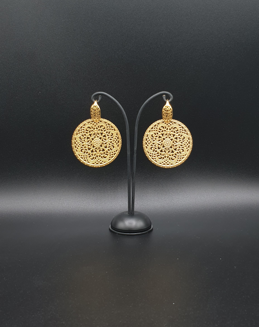 golden metal stud earrings with ornamental elements